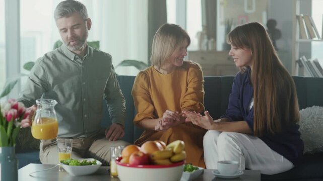 Sunlit kitchen with family sharing meal, An intimate family moment in bright kitchen with supportive interactions