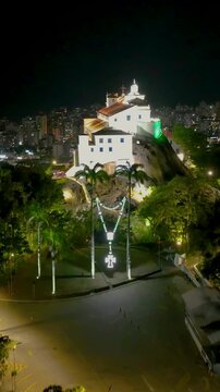 Penha Church At Vitoria Espirito Santo Brazil. Breathtaking Aerial View Of Famous Church In The City. Night Freeway Road Downtown Cityscape. Night Outdoors Panning Wide. Vitoria Espirito Santo.