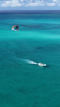 Parasailing At Providenciales In Turks And Caicos. Idyllic Beach. Nature Landscape. Aquatic Sport. Parasailing In Turks And Caicos. Aquatic Sport Landscape.