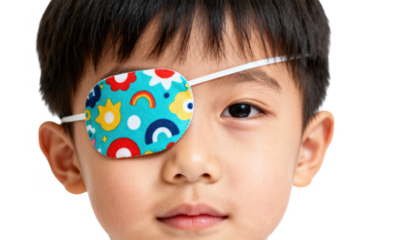 Closeup photo of a childs stronger eye covered by a fun patterned eye patch against white background symbolizing eye patch therapy to strengthen the weaker eye.