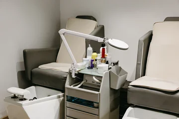 Fotobehang Pedicure Modern pedicure station with two professional chairs in beauty salon  © Raquel