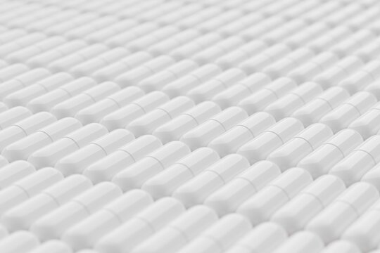 White pills on red surface. Close-up shot, selective focus