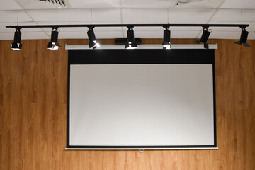 Blank Projection Screen with Track Lighting in Modern Interior
