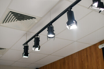 System of a modern LED spotlight on ceiling. Selective focus.