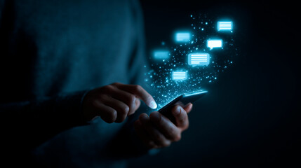Person using mobile device with futuristic chat interface, focusing on AI and communication technology in dark background for tech-related content