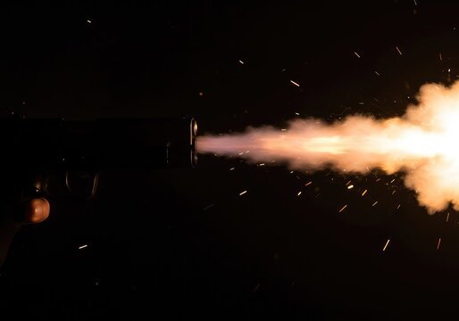 Explosive discharge of a firearm, creating a bright muzzle flash against a dark backdrop, emphasizing intense heat and violent action ,bright ,sudden ,conflict