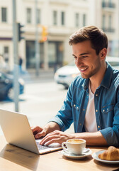 Young man using laptop and smiling  