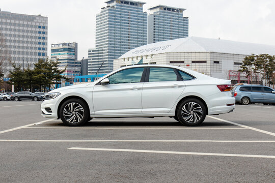 January 31, 2021, Seoul, South Korea - A white Volkswagen Jetta sedan parked in a city parking lot.