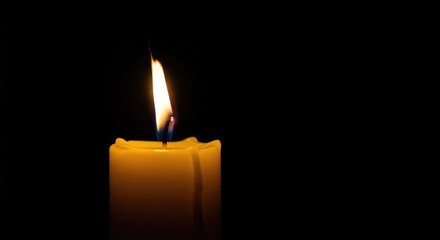 A vibrant close-up of a warm yellow candle flame flickering gently in the dark, providing light and comfort during quiet moments ,illumination ,contemplation ,peace