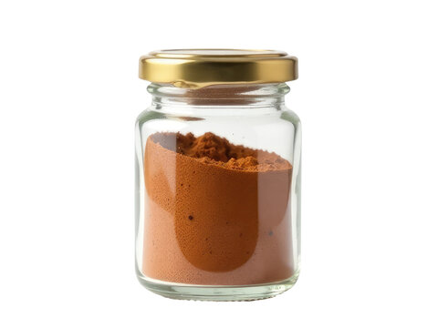 A glass jar filled with brown powder on a white surface