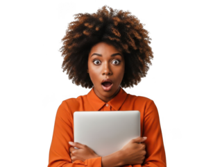 Surprised young Black woman with an afro holding a laptop, with wide eyes and an open mouth, wearing an orange shirt. isolated on transparent background