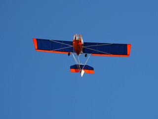 Red and Blue Light Aircraft Flying Over a Trail in November, Boulder, Colorado