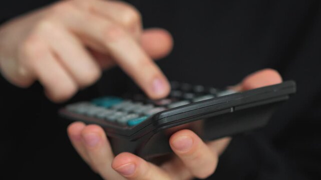 A close-up of a banker using a calculator.
A banker calculating something on a calculator.
Finance and credit.
Financial accounting and bookkeeping - Powered by Adobe
