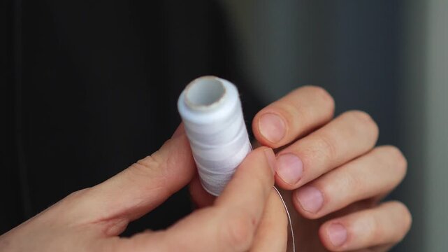 Thread for hand-sewn clothing.
A roll of white knitting thread.
White thread for repairing torn clothing.
Clothing, handmade, sewn, roll, white
