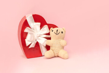 A romantic Valentine's Day gift card featuring a teddy bear, a heart-shaped box with a bow. Festive background. HOLIDAY mother's day