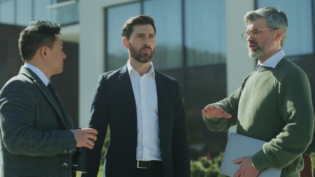 Leadership figures engage passionately outdoors, Corporate leaders confront each other outside professional setting