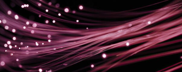 Abstract pink light trails and glowing bokeh particles on a dark background