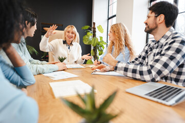 Diverse business team collaborating during corporate meeting. Professional managers planning project