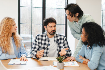 Diverse group of professional managers collaborating working in modern office