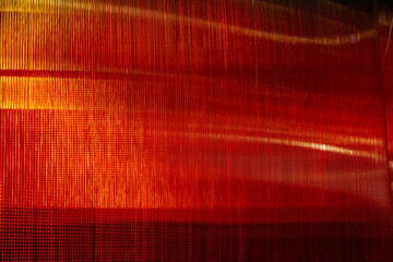 Abstract blurry background in orange and yellow tones featuring symmetrical pattern.An optical fiber is a cylindrical dielectric waveguide (nonconducting waveguide) that transmits light along its axis