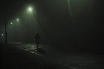 A woman walking in the foggy night