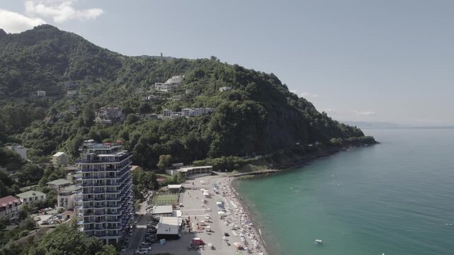 Aerial view of the Kvariati coastline in Adjara, Georgia, featuring seaside resorts, green hills, and the calm Black Sea. Peaceful coastal landscape with hotels, shoreline, and mountain backdrop