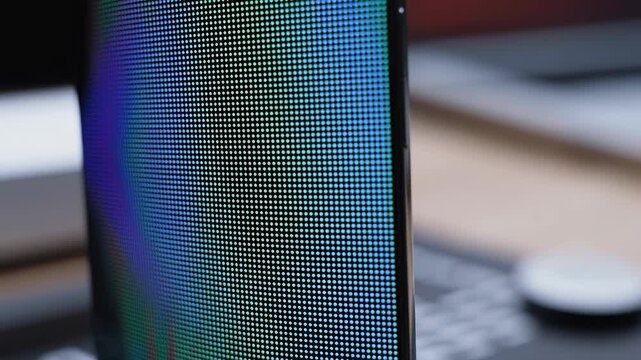 Macro closeup of dynamic led screen colors and patterns in vertical motion