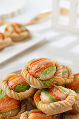 Delicious colorful cookies stacked on a plate, perfect for dessert or snack