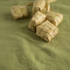 Woven rice cakes on a textured green fabric surface