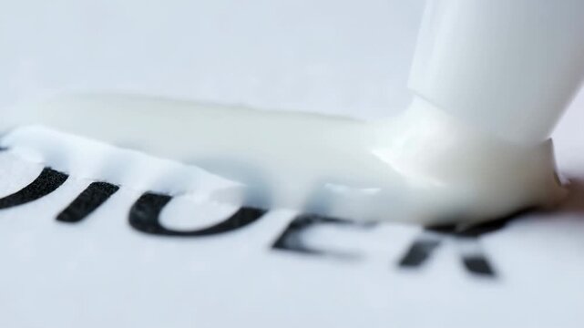 Liquid correction fluid over text  covering mistakes and imperfect prints on paper