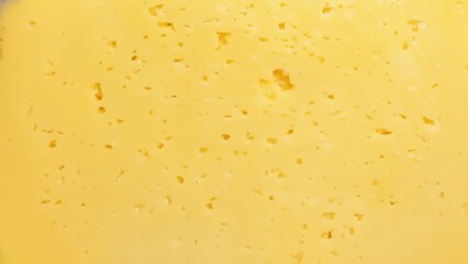 Close up of yellow cheese with small holes