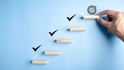 Hand places block on stairs towards target with checkmarks.