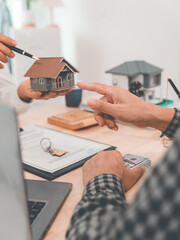 The customer is negotiating a home purchase agreement, with basic information regarding insurance or a home loan, after the bank has approved and signed the purchase agreement.