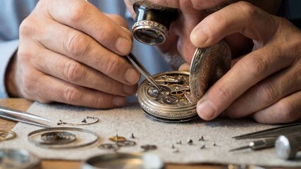 An experienced watchmaker meticulously repairs a vintage pocket watch using precision tools, demonstrating the art of horology and the dedication to craftsmanship.