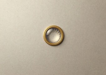 Elegant Opulent Gold Medallion Ornament with Spiral Design on Muted Cream Texture