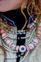 Intricate Layered Jewelry Featuring Pearls and Unique Beads