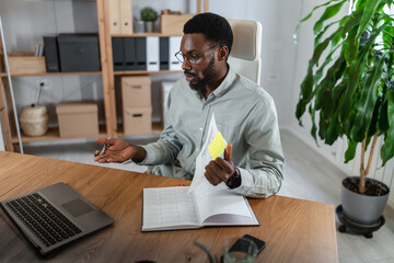 African American man in a video conference from a home office, presenting and explaining business reports during an online meeting, analyzing documents and discussing results with clients