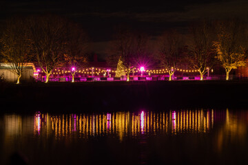 Court Palace ice rink colourfully lit at night in winter