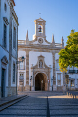 Arco da Vila, the historic gateway in Faro, Algarve, Portugal, featuring elegant stone architecture, decorative archways, and cobblestone streets in the heart of the old town.