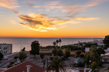 Majestic sunrise in Lagos, Portugal with buildings visible. Photo taken towards Ponta da Piedade.