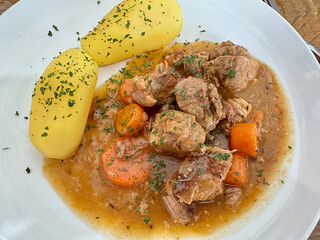 Beef Stew with Carrots and Boiled Potatoes on White Plate
