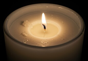 Capturing the molten wax pool and glowing cotton wick nestled deep within a thick, cylindrical white candle, emphasizing texture and heat ,surface ,flame ,atmosphere
