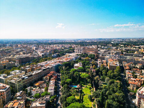 Epic Roman park aerial panorama. 
Cinematic drone view of 
Aurelian Walls greenery and 
umbrella pines in Rome, Italy. 
Historic city landscape at dawn.
