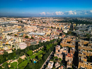 Fototapeta premium Epic ancient Roman walls panorama. Cinematic aerial view of Aurelian Walls and historic cityscape in Rome, Italy. Urban heritage reveal. 