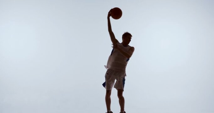 Basketball athlete preparing controlled overhead shot in elevated position. Concept of shooting mechanics, digital coaching tools, movement breakdown, and technique refinement.