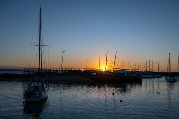 Obraz premium sunset over boats in the harbour at Hill Head Hampshire England