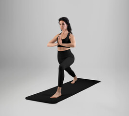 Template of black unfolded floor mat, trainer in asana, dressed in top, leggings, front view in full height.