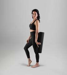 Template of black rolled up floor mat in trainer's hand, side view, isolated on background.