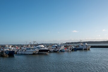 Fototapeta premium Poole England - December 25 2025: boats in the harbour in Poole Quay Dorset England