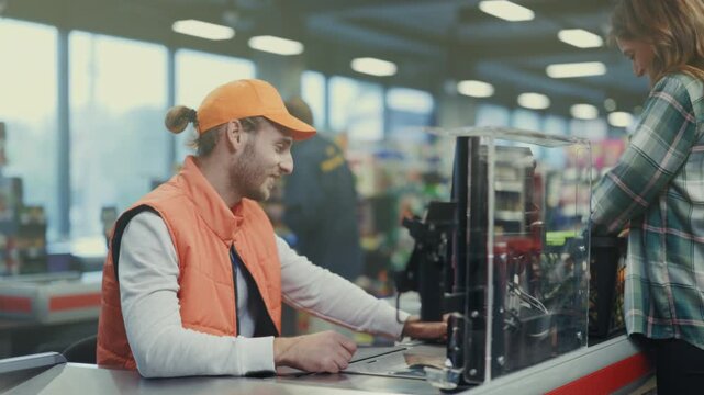 Cashier helps customer confidently, Cashier in orange vest assists customers amidst cheerful store environment